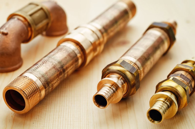 plumbing tools on a light woody background.